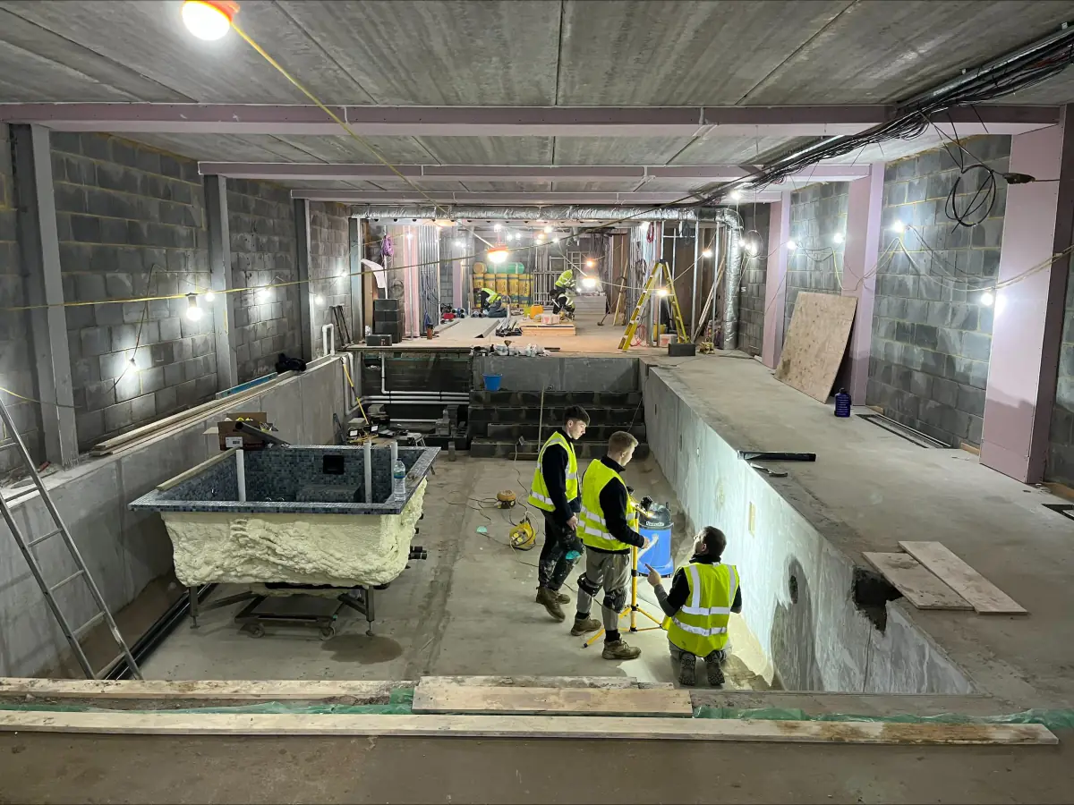 Site team in hi-vis working on a leisure complex pool under construction